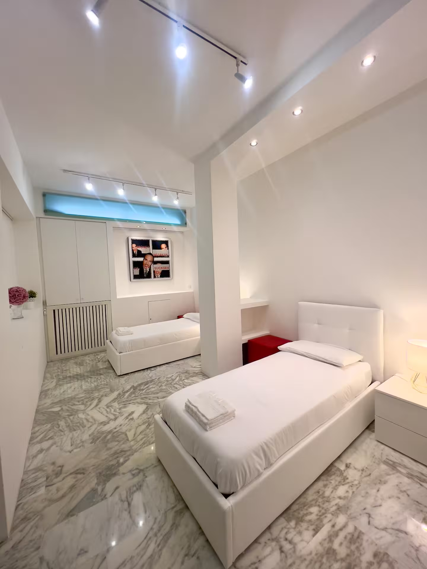 Open-plan family sleeping area with double bed and two single beds