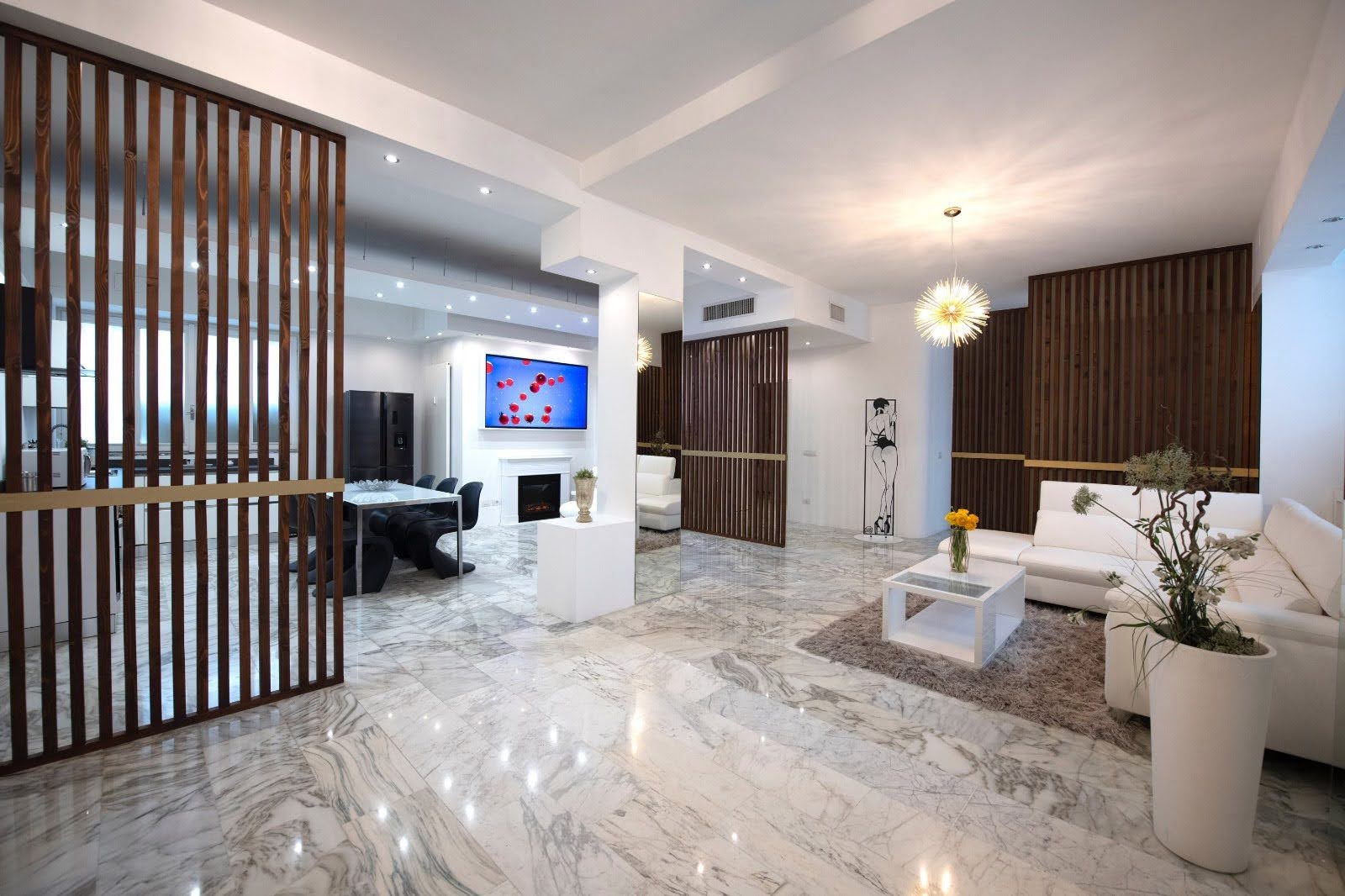 Wide marble living room with white sofa, wood slat dividers and chandelier at La Galleria Milano