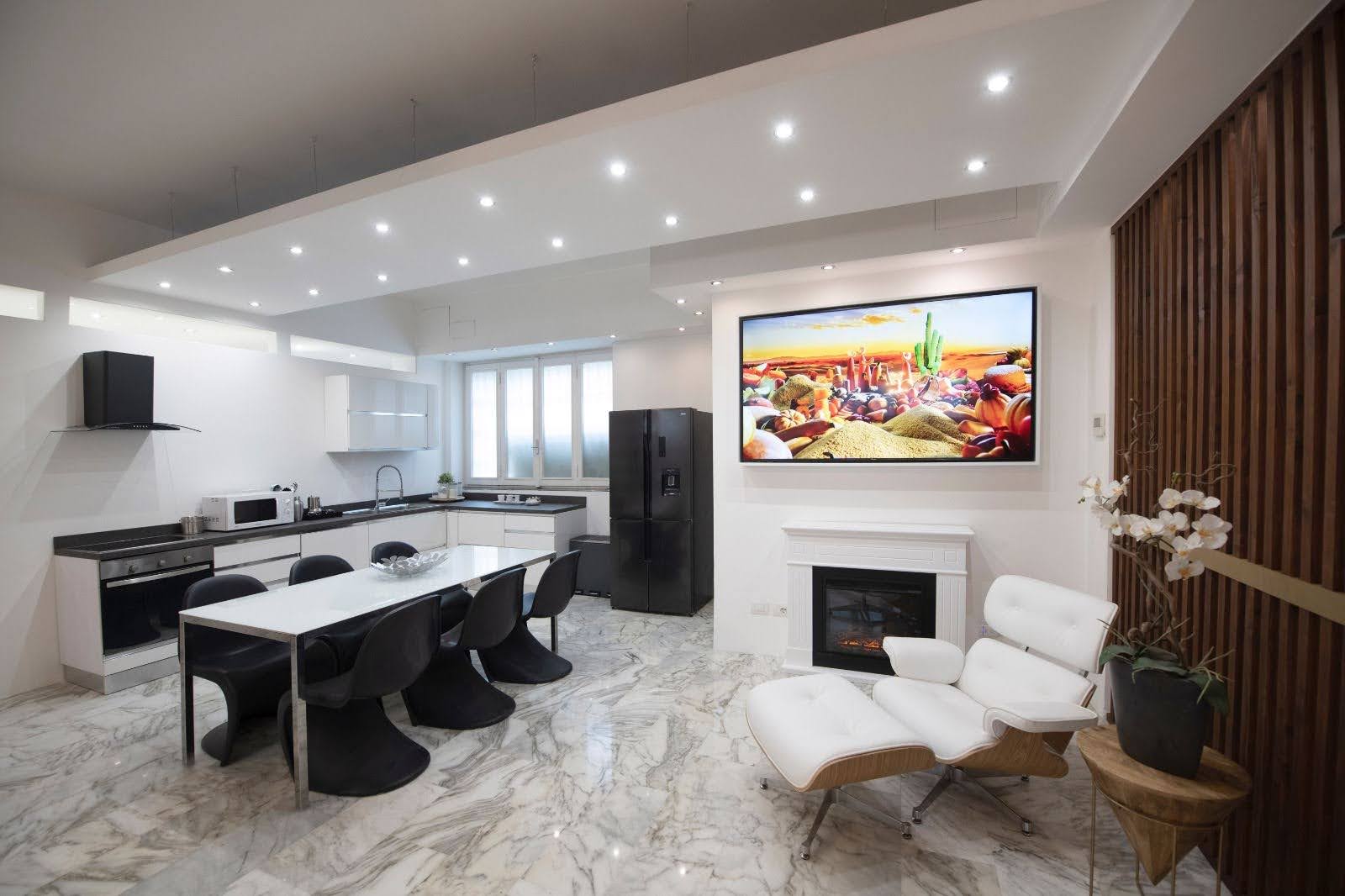 Kitchen and dining space with fireplace in a luxury Milan design apartment