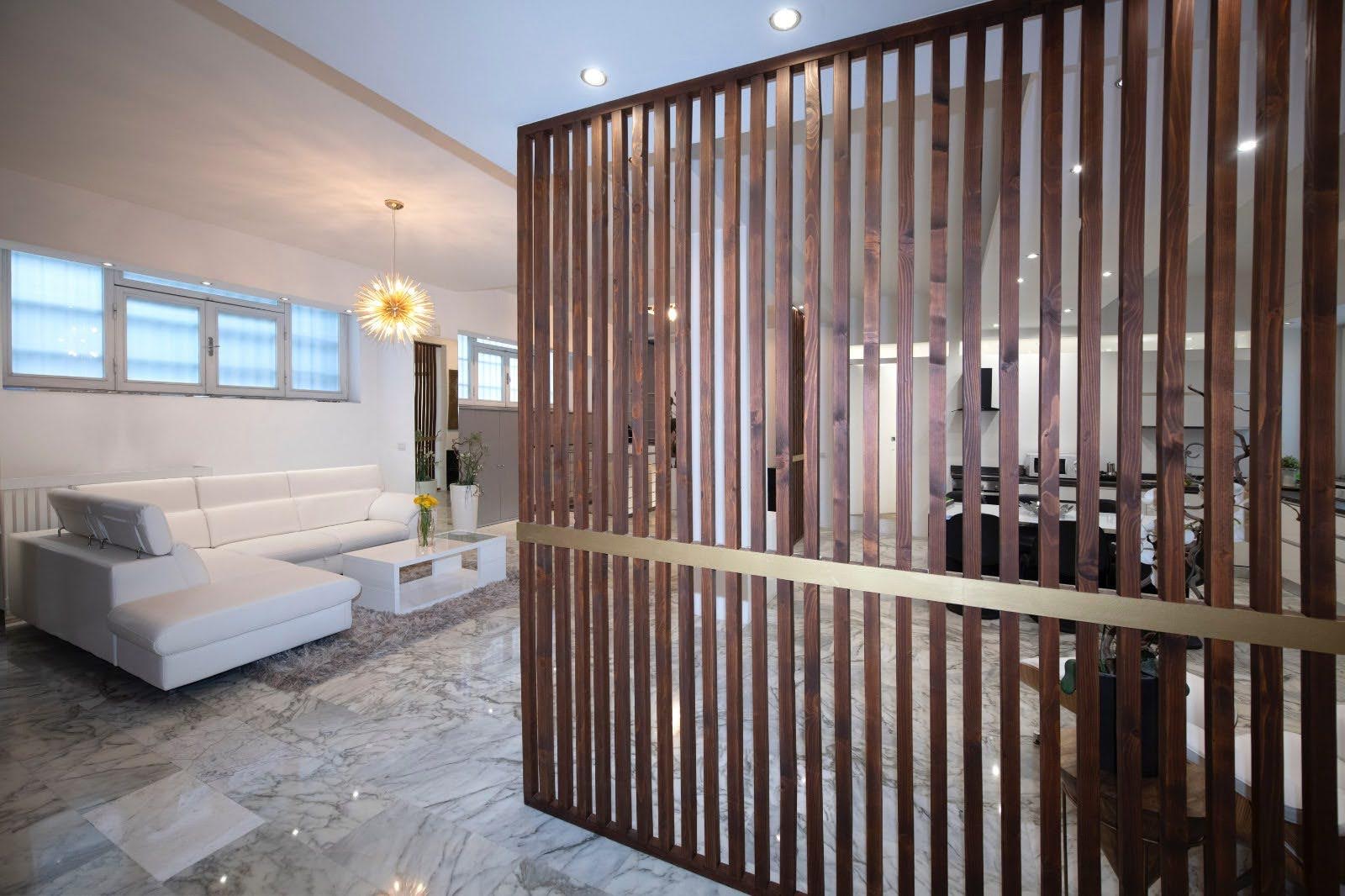 Walnut divider and chandelier detail framing the living and dining areas