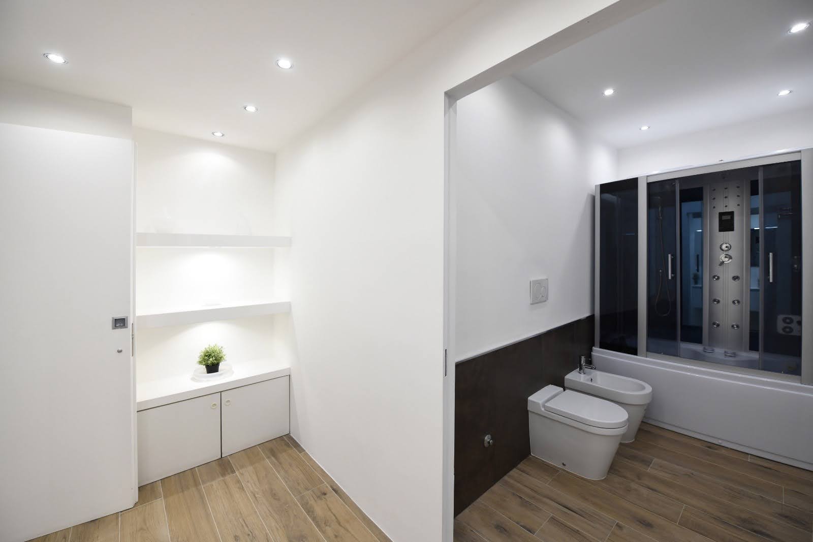 Wide private wellness bathroom with jacuzzi tub, steam shower and ante-bathroom view