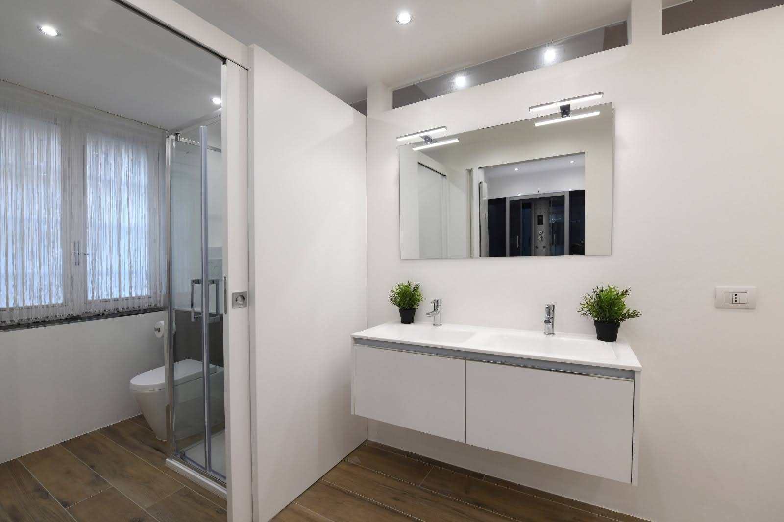 Double sink vanity with warm lighting in the private wellness space